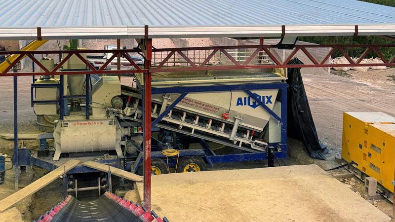 Construcción de viviendas rurales con planta de concreto pequeña AIMIX en zonas periféricas de Guatamala, equipo compacto para cimentaciones y losas.